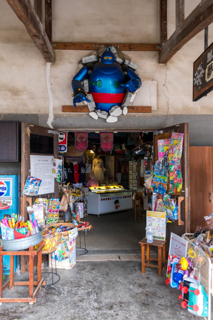Entrance of Showa museum, with robot breaking from the wall, and various nostalgic candies and goods, at Showa no Machi, Oita prefecture.