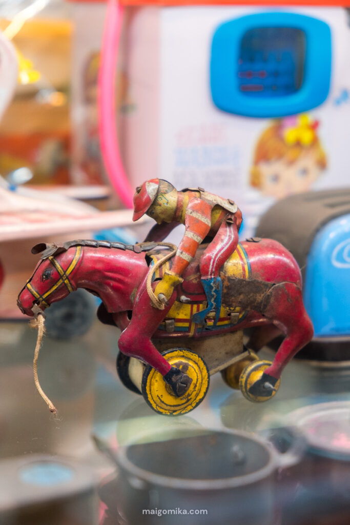 A retro jockey and horse toy in a Japanese museum.