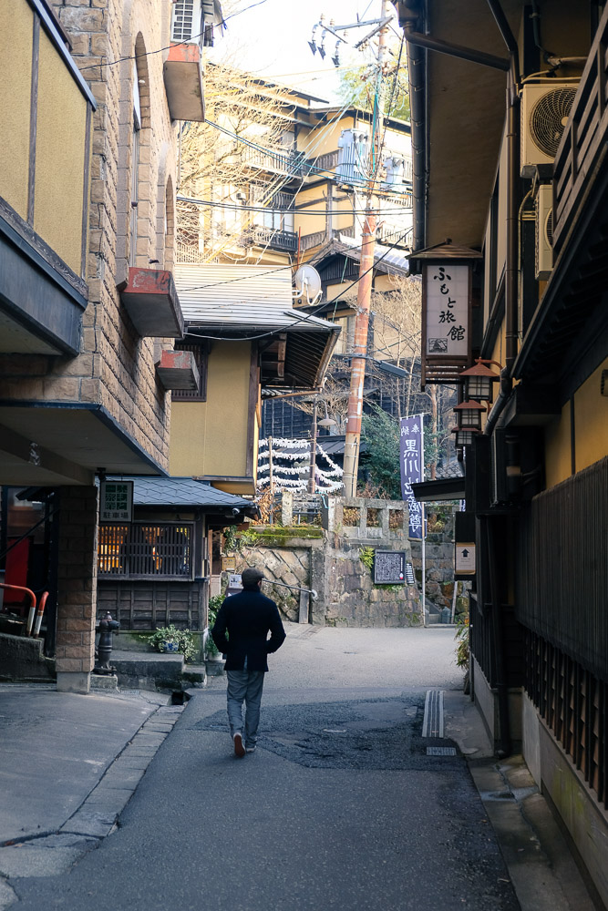 man strolling through Kurokawa Onsen in Kumamoto Prefecture.