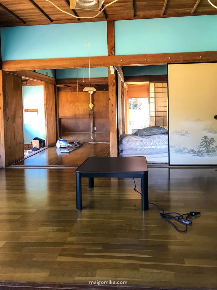 interior of an old traditional japanese house, an akiya, with a kotatsu in the middle of the room