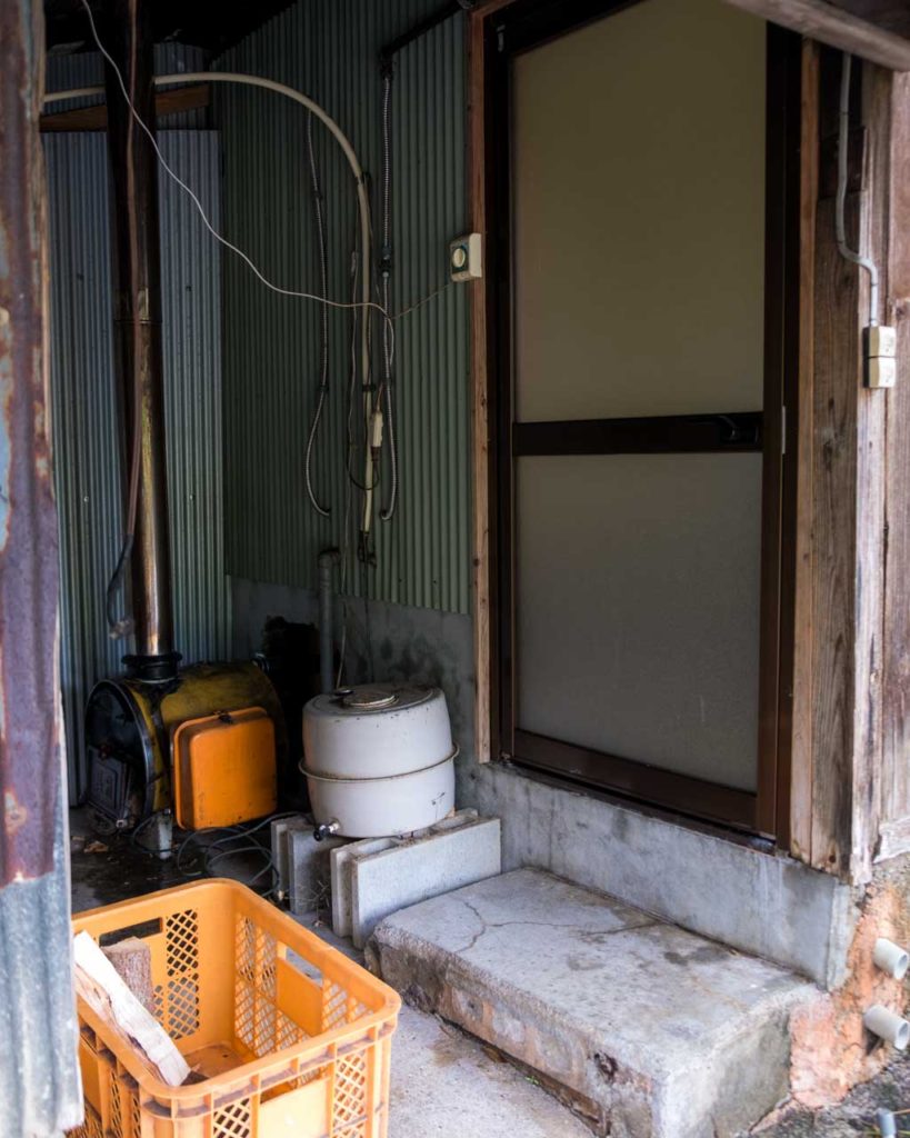 outbuilding with wood stove connects to bath