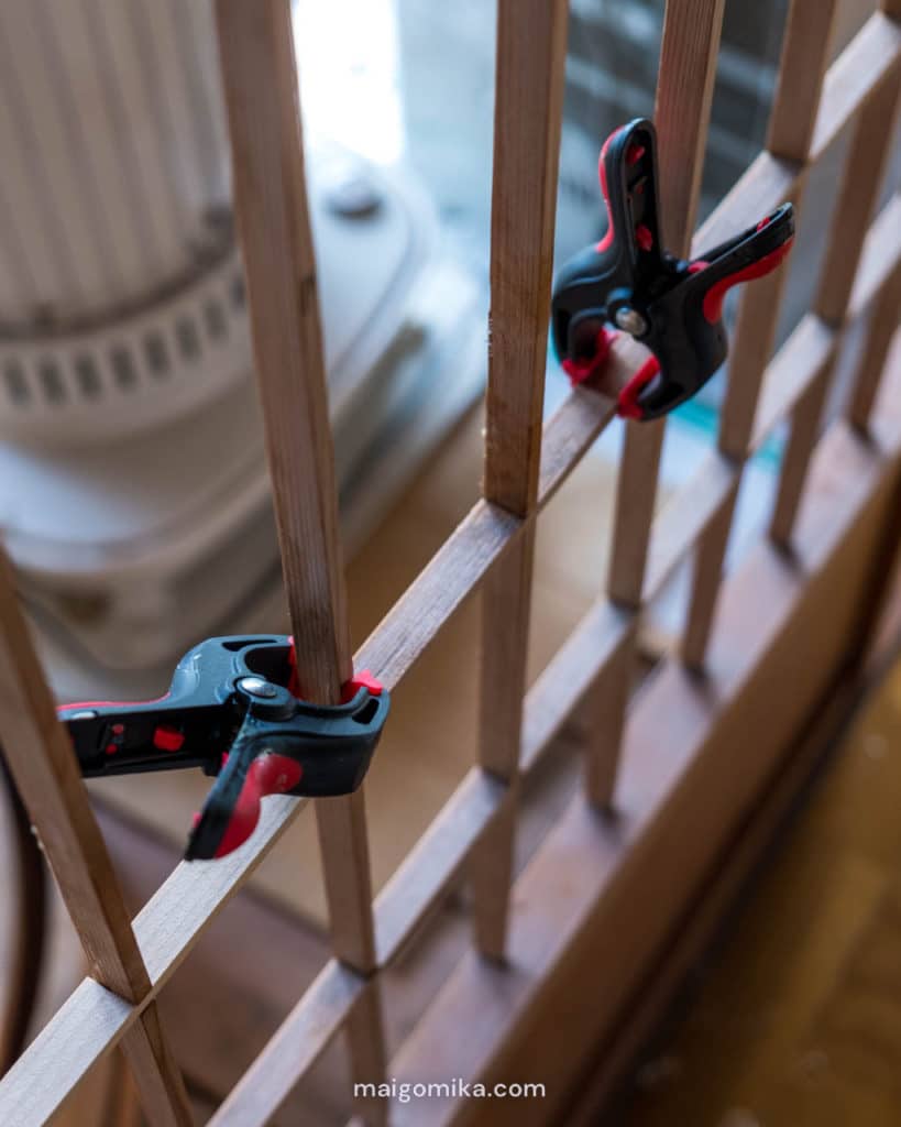 two clamps on Japanese shoji screen during repair process