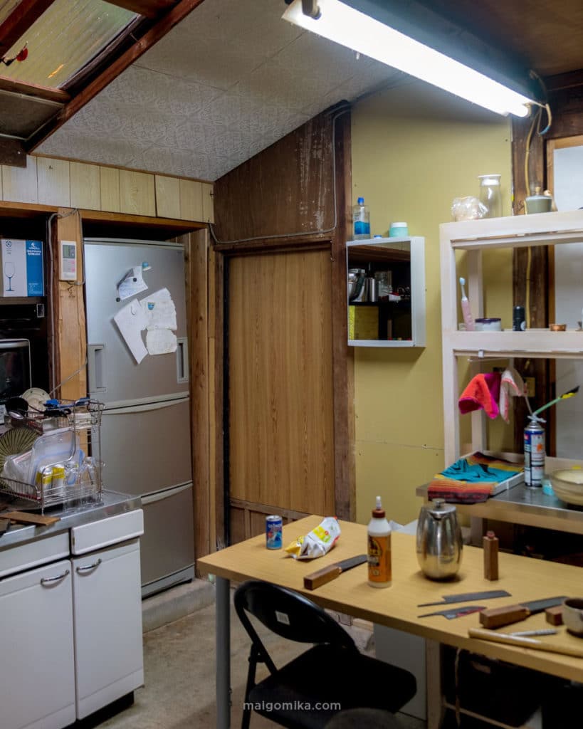 old Japanese kitchen with bathroom vanity installed on wall with building supplies on table