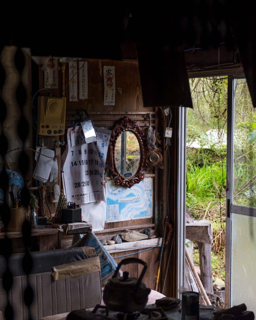 inside an akiya house, one of Japan's abandoned houses, with mirror and old calendar on one wall.