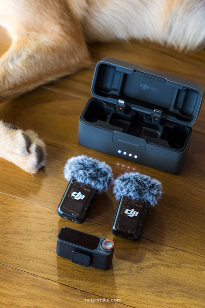 dji mics, part of a youtube equipment and gear list, next to open case on the floor