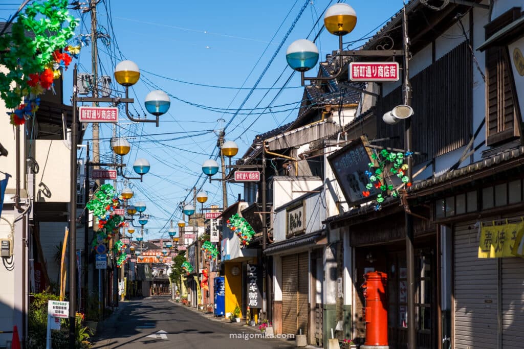 A retro Japanese shopping street lined with amber and turquoise lamps lining the street at Showa no Machi, Oita prefecture.  
