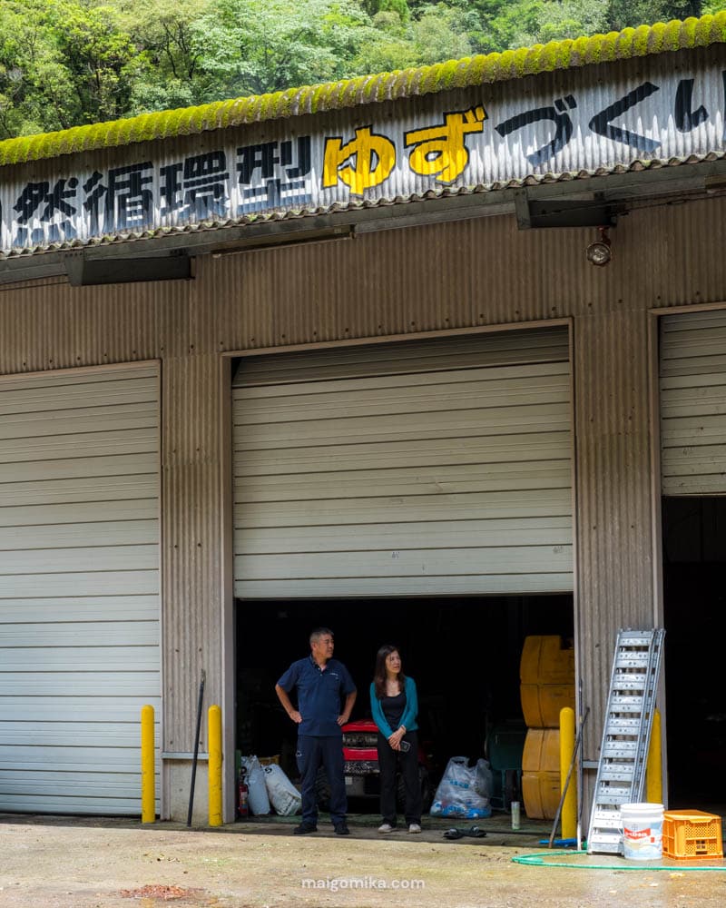 Two people standing in a composting facility in Umaji village, Japan