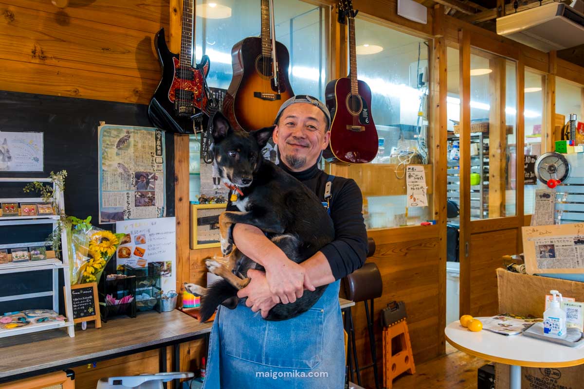 Man holding dog in a Japanese cafe in Umaji village, Kochi.