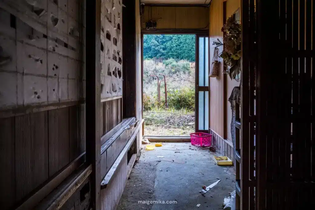 an old doma (dirt floor) hallway with shoji doors inside an akiya house in Japan