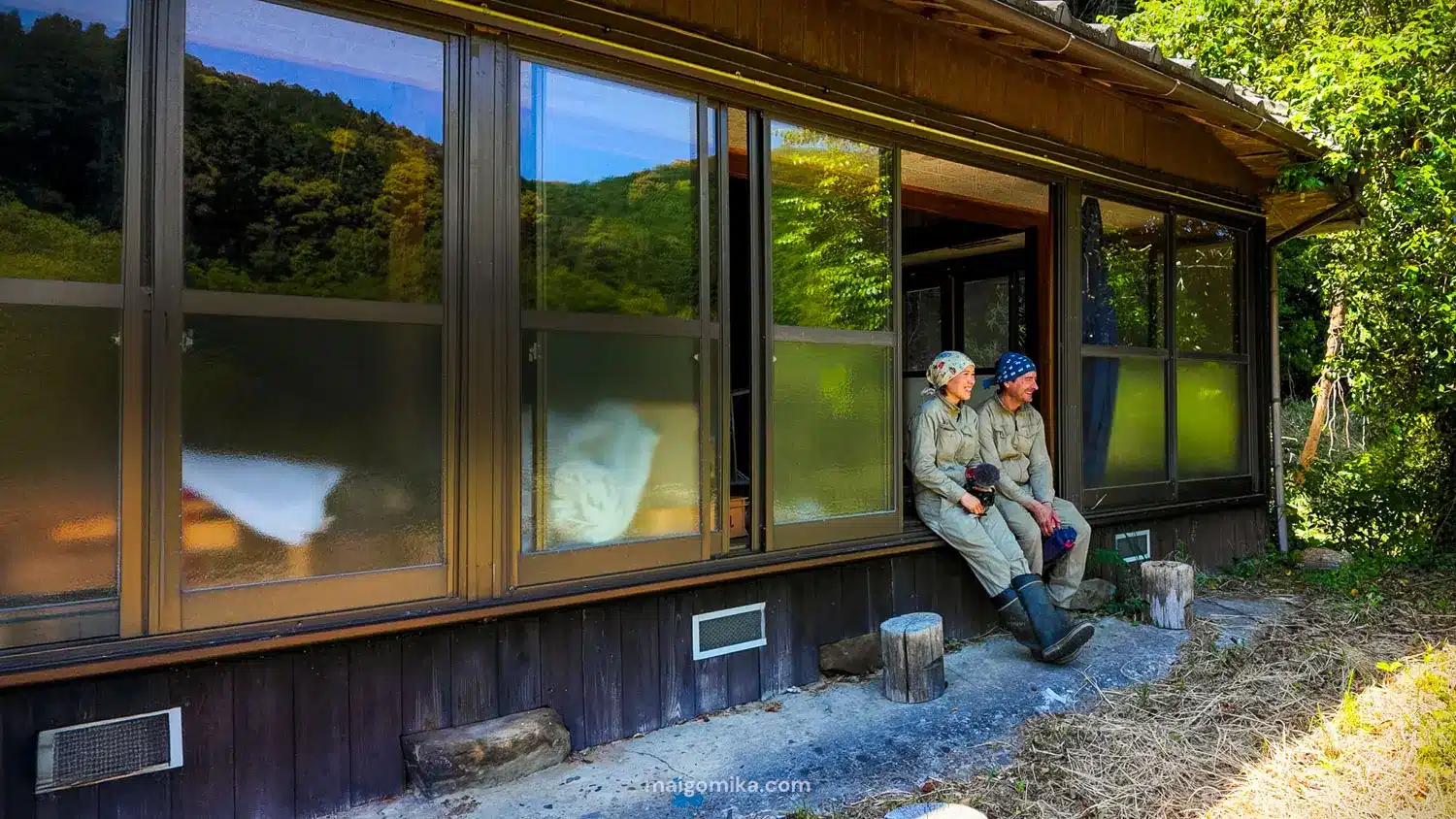 two people sitting on an engawa deck in a Japanese house